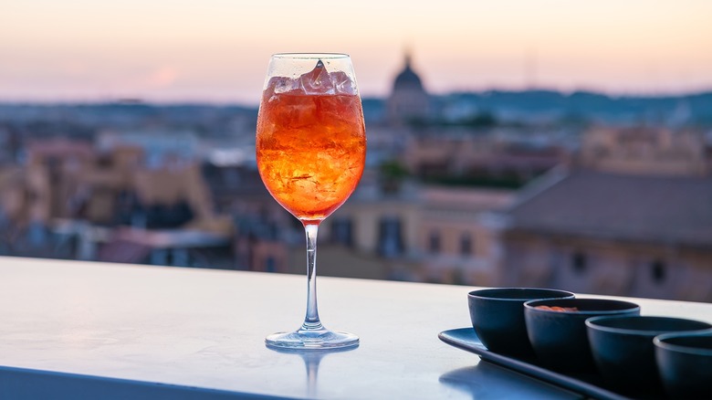 An Aperol spritz with Rome in the background.