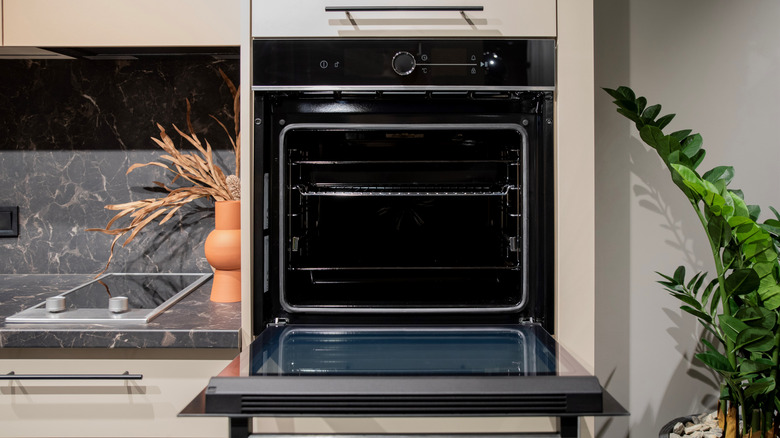 A black wall oven with an open door.