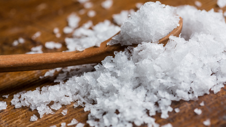 Maldon sea salt packed on a small wooden spoon