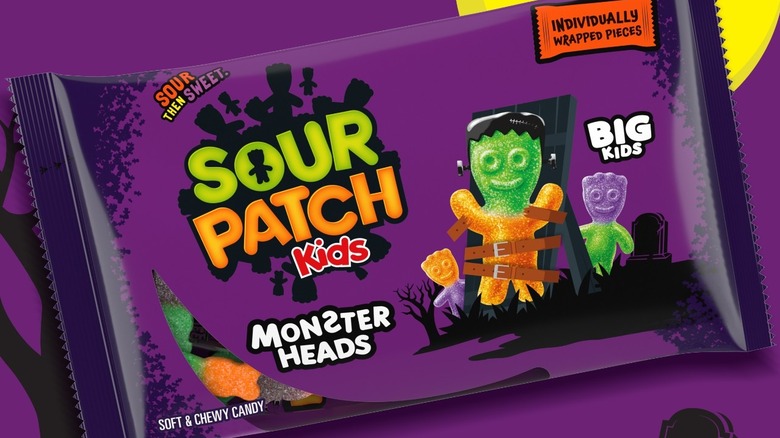 An individual pack of Sour Patch Kids Monster Heads sits against a purple background