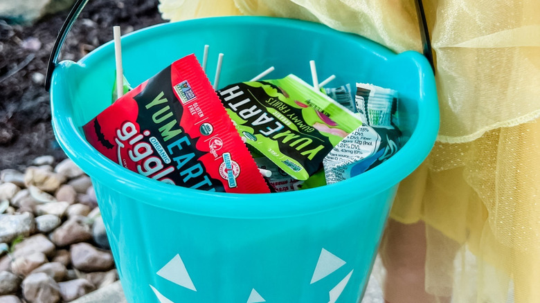 A bucket contains YumEarth Organics Halloween Candies