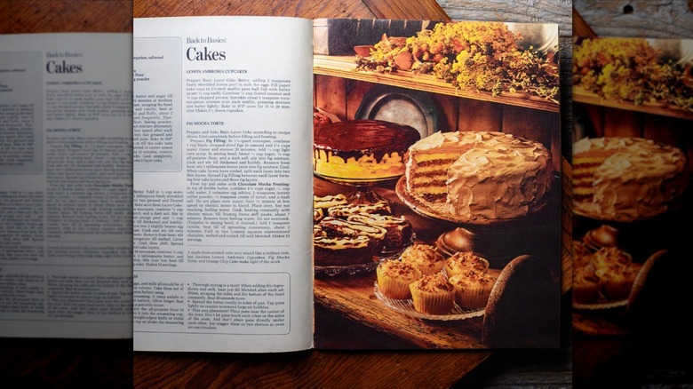 A copy of "Better Homes and Gardens Treasury of Baking Recipes" lies open on a wooden surface