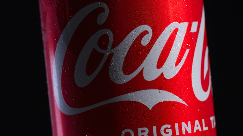 Closeup of a Coke can with condensation beading on it