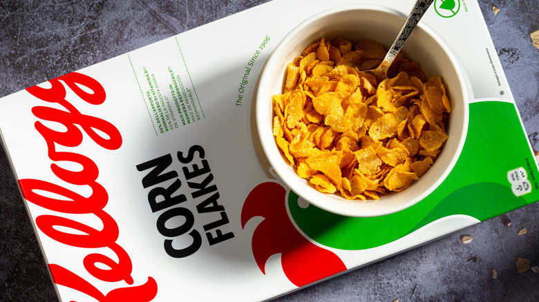 A bowl of Kellogg's Corn Flakes sits on top of the cereal box