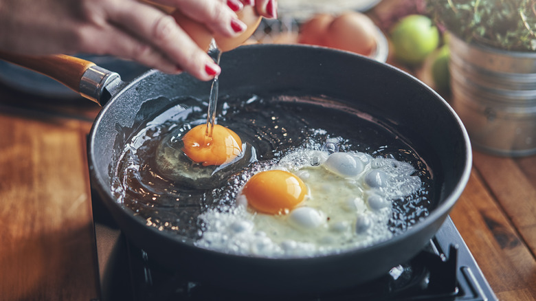 eggs being cracked into pan