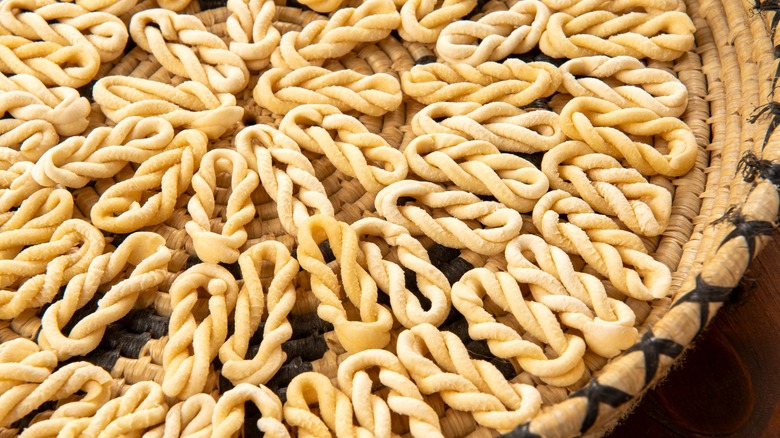 Basket of raw braided lorighittas pasta