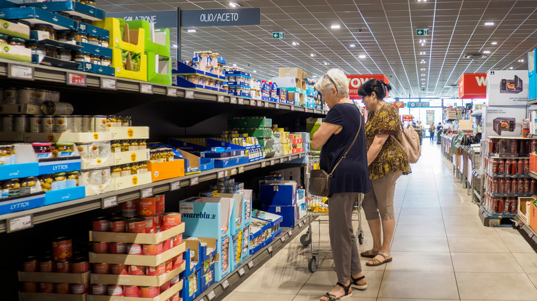 shoppers browse products on Aldi shelves