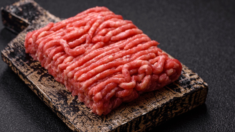 Ground beef sits on a cutting board