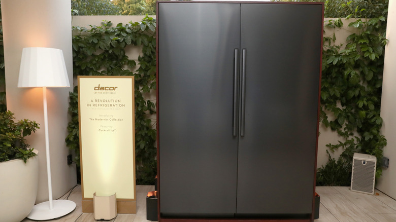 A Dacor fridge next to a lamp and sign