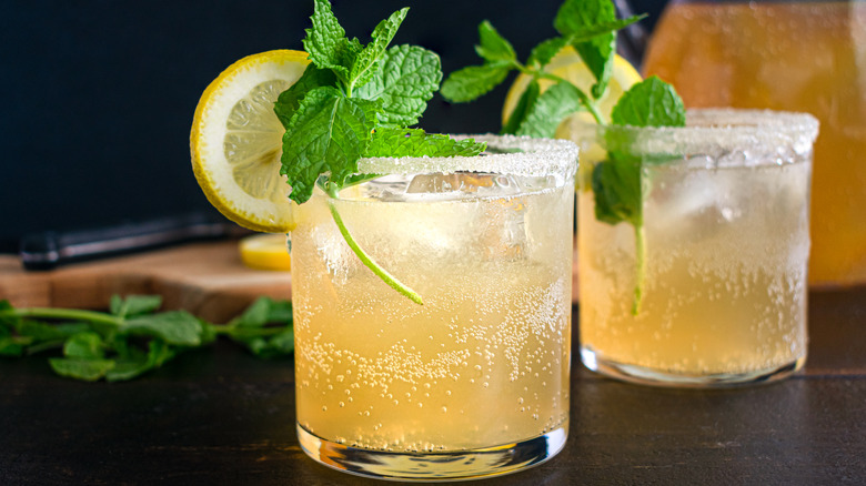 A bourbon lemonade cocktail garnished with mint.