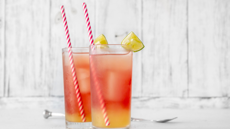 Two vodka sea breeze cocktails served with straws.