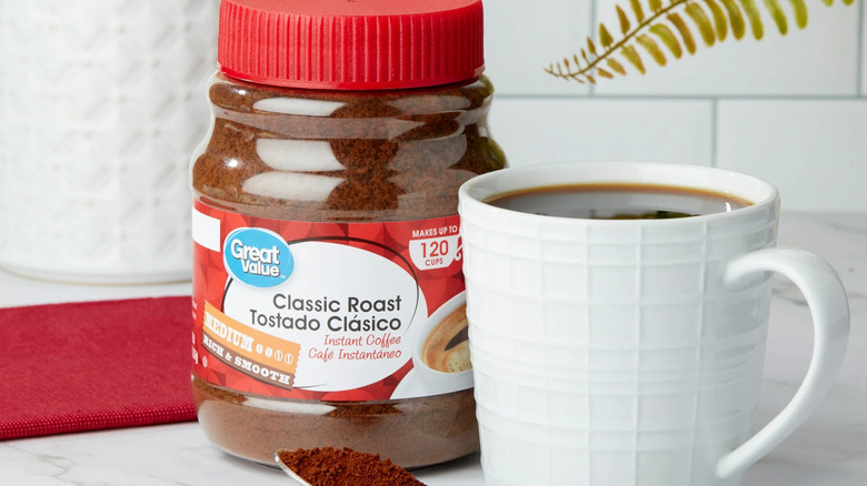 Great Value's Classic Medium Roast Instant Coffee jar next to a freshly brewed cup of coffee