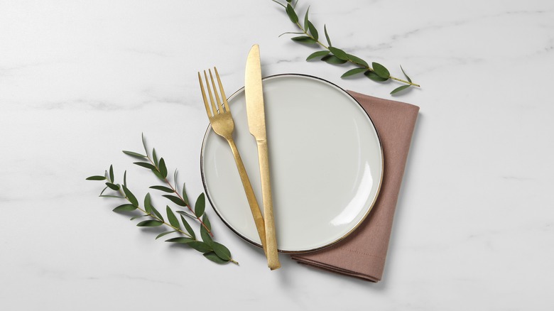 plate with golden set of cutlery