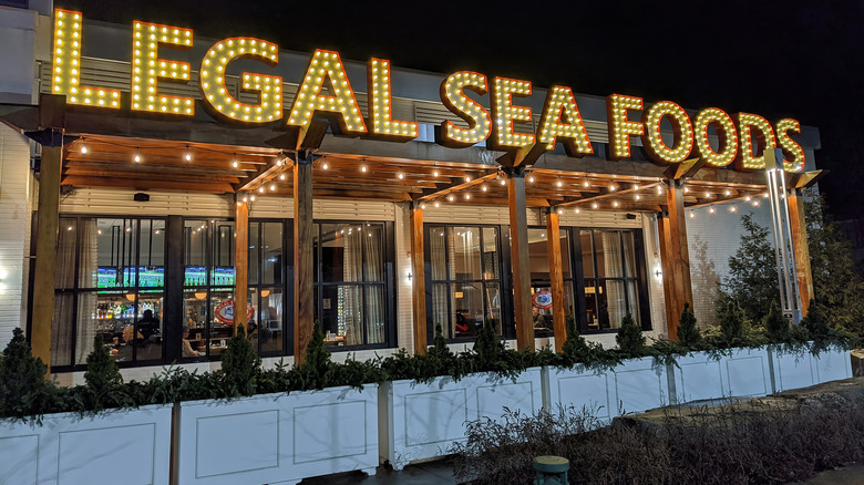 exterior of Legal Sea Foods restaurant with lit up sign at night