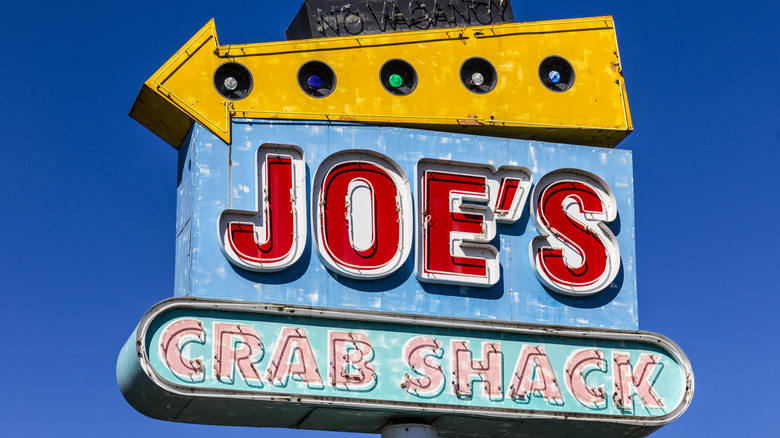 close up of Joe's Crab Shack sign against a blue sky