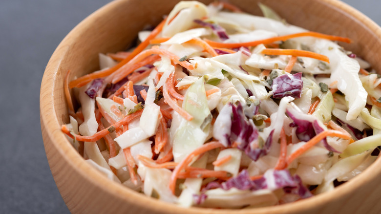 Coleslaw in a bowl on a black slate background.