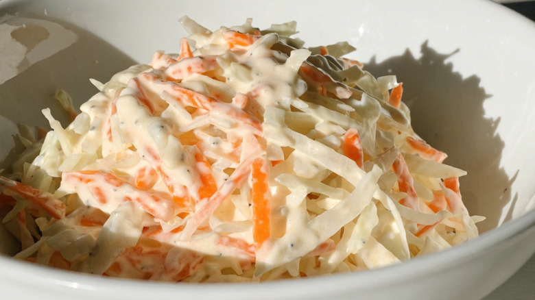 Close up of creamy coleslaw in a bowl.