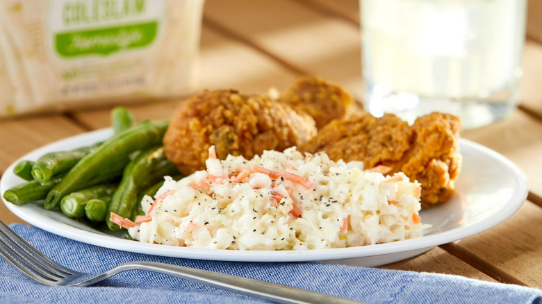 Walmart Freshness Guaranteed Homemade Style Cole Slaw on a plate with green beans and chicken.