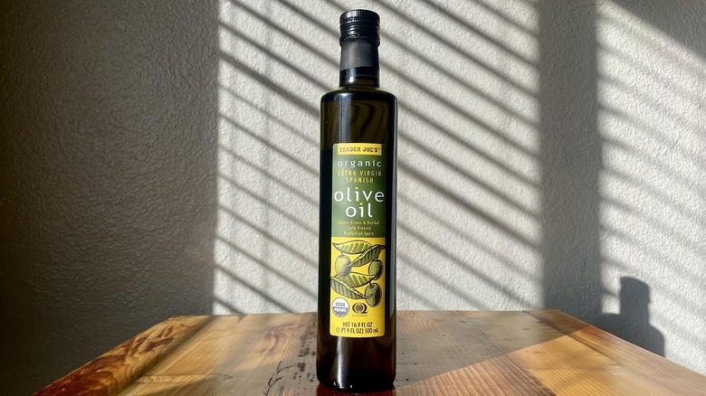 Bottle of Trader Joe's Organic Extra Virgin Spanish Olive Oil on a wooden table
