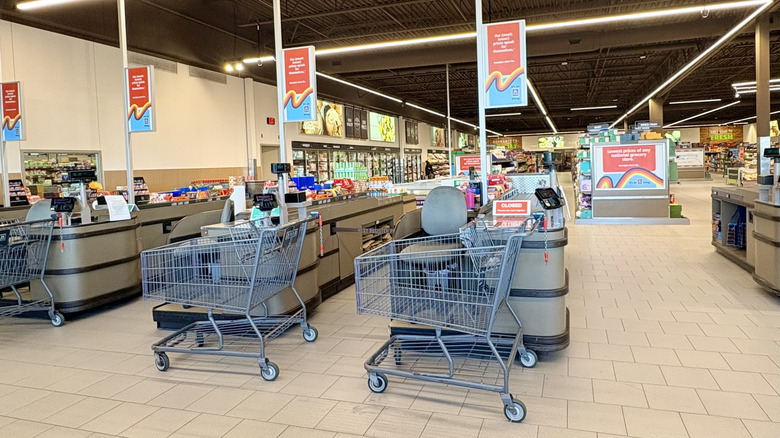 Aldi shopping carts lined up at the end of checkout registers.