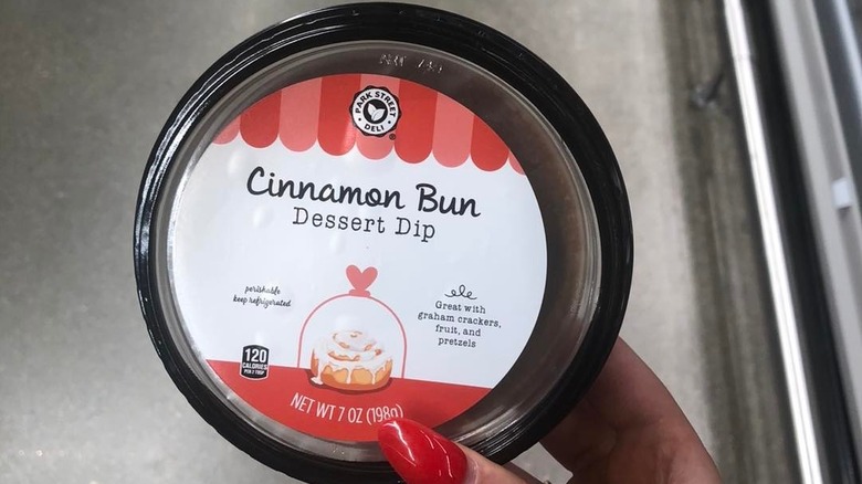 Person holding the cinnamon bun dessert dip jar