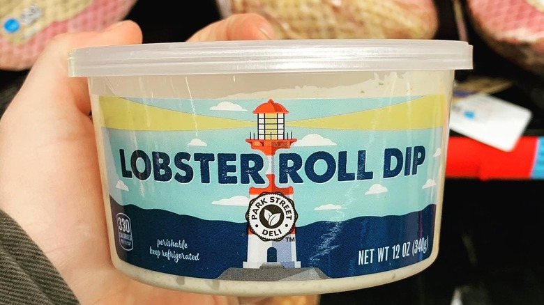 Person holding a jar of Lobster Roll Dip