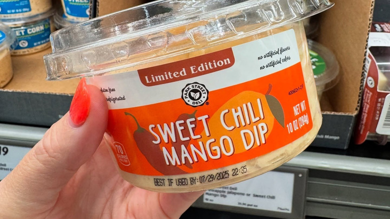Person holds a sweet chili mango dip