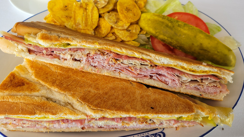A traditional Tampa-style Cuban sandwich served on Cuban bread with plantain chips