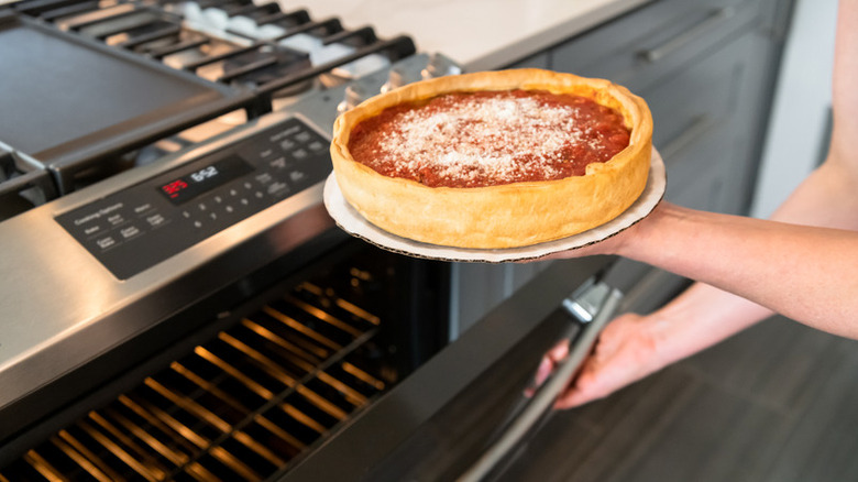 Giordano's deep dish pizza taken out of an oven.