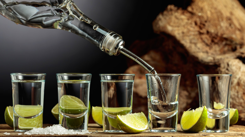 Pouring tequila shots with lime