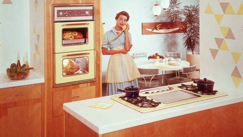 Housewife on the phone in her 1950s kitchen