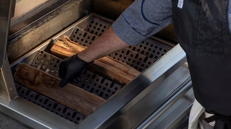 The Freestanding Hybrid Fire Grill by Kalamazoo with wood