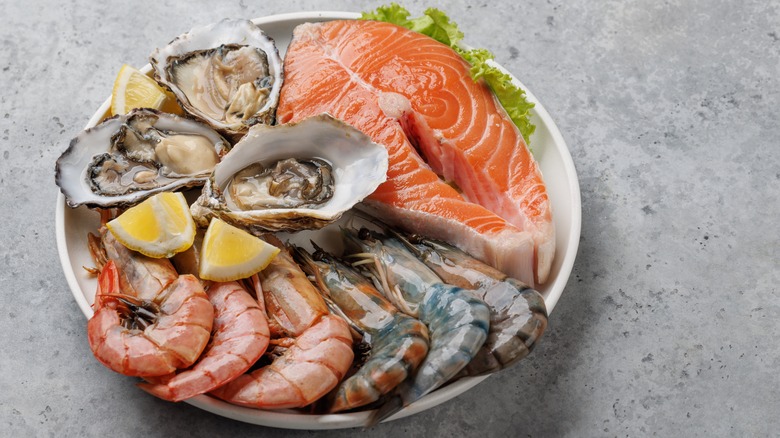 a seafood platter with fish, shrimp, and oysters