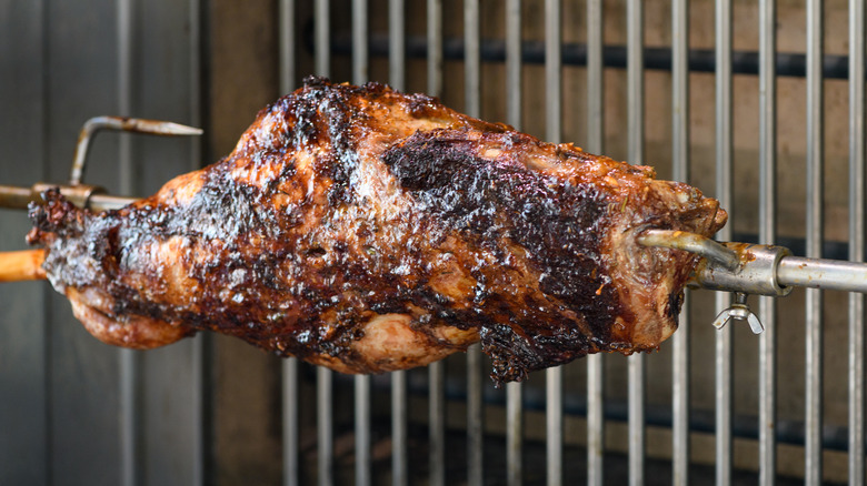 a hunk of mutton roasting on a spit