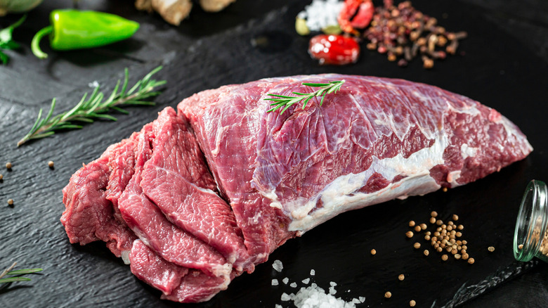 a cut of veal on black wood