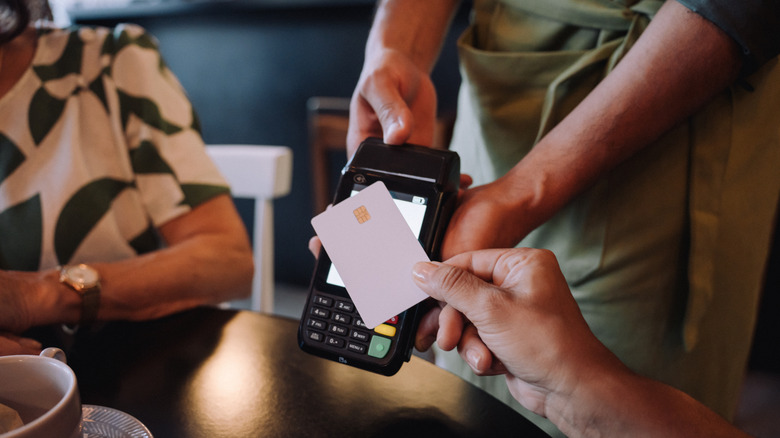 Paying with a credit card on a portable POS in a restaurant