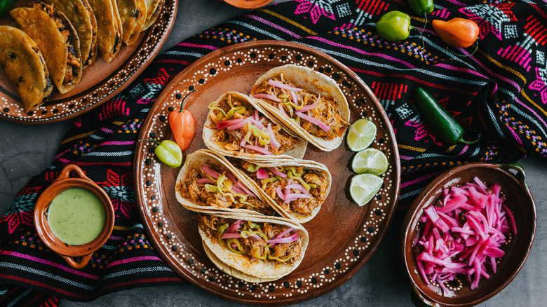 A plate of tacos and accoutrements