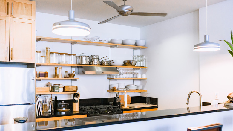 Wooden, symmetrical open shelves in a modern kitchen