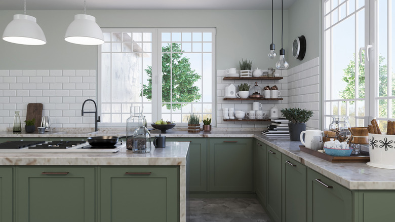 Modern kitchen with a green color palette and dark wood open shelving