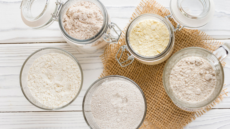Overhead view of different types of flour in glass jars