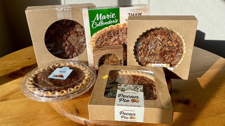 Six different store-bought pecan pies in their packaging