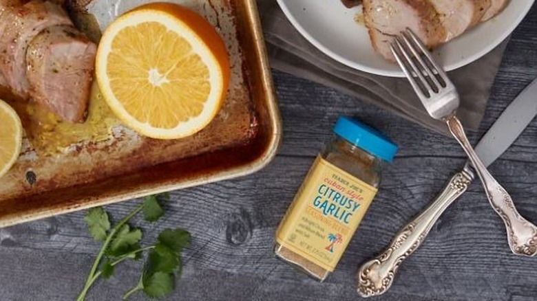 Jar of Trader Joe's Cuban Style Citrusy Garlic Seasoning Blend with citrus-glazed pork medallions