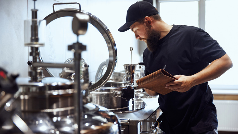A worker overlooking the brewing of beer