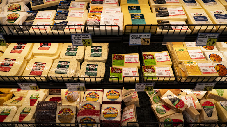 Various cheeses for sale in a grocery store