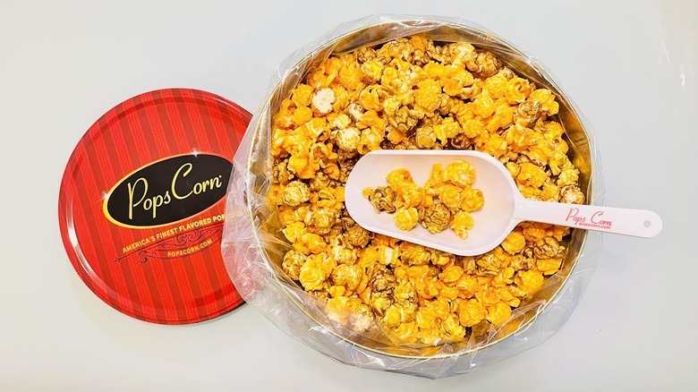 Opened tin of Pops Corn popcorn with scoop