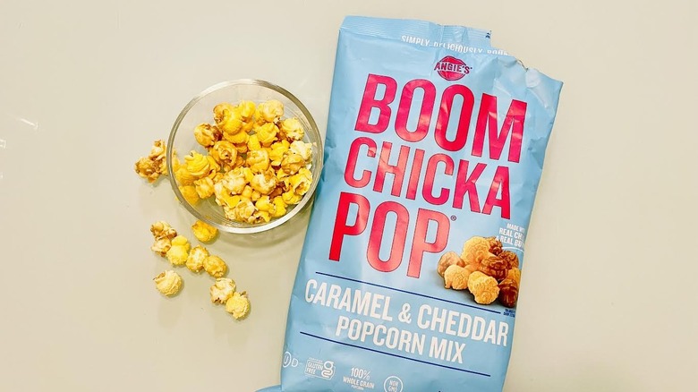 Open bag of Angie's Boom Chicka Pop popcorn with small dish on side