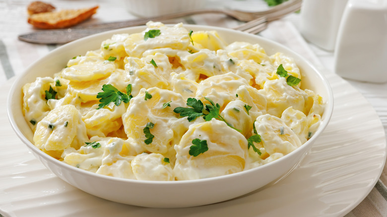 High resolution image of potato salad with cilantro in a big white bowl.