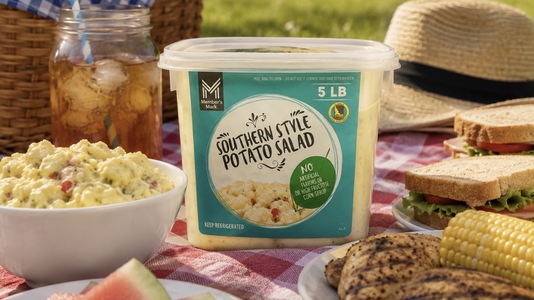 Sam's Club Member's Mark Southern Style Potato Salad sitting on a picnic blanket amid other dishes.