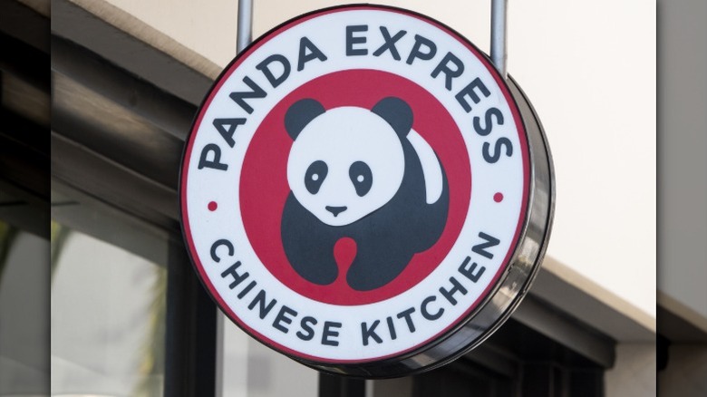 A Panda Express Chinese Kitchen sign hangs outside the restaurant