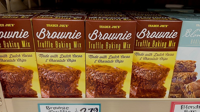 Rows of Trader Joe's Brownie Truffle Baking Mix sit on the store's shelves
